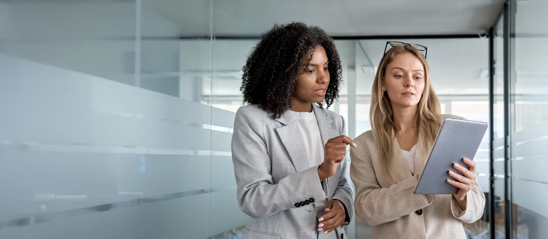 Two businesswoman working together using digital work tablet pc business project