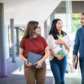 Eine gemischte Gruppe von msg-Mitarbeitenden in einem hellen Korridor am msg-Standort Ismaning