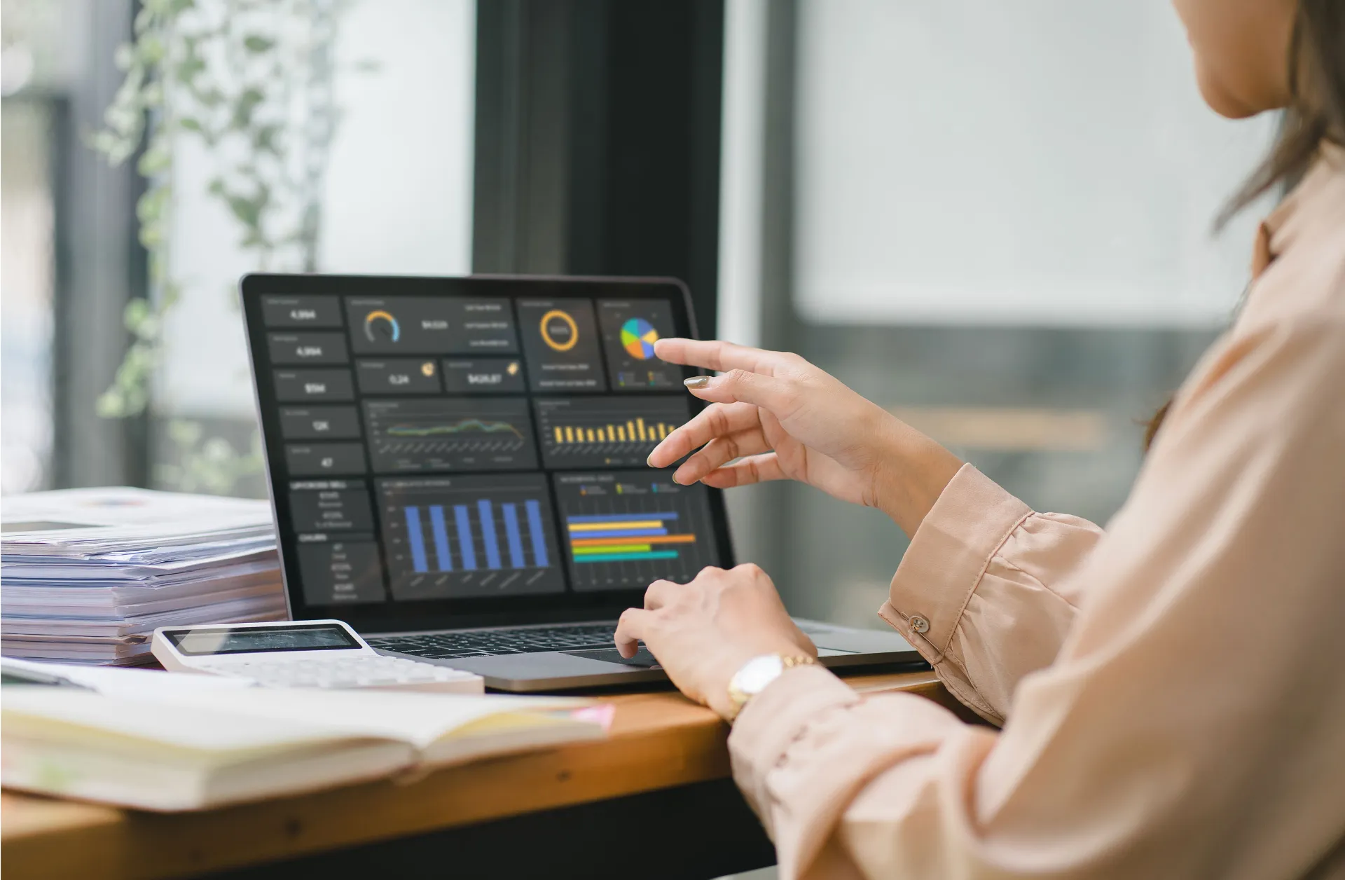 The female analyst utilizes a computer and a dashboard for business data analyze and a data management system with KPI. The concepts of technology, finance, operations, sales, and marketing. 